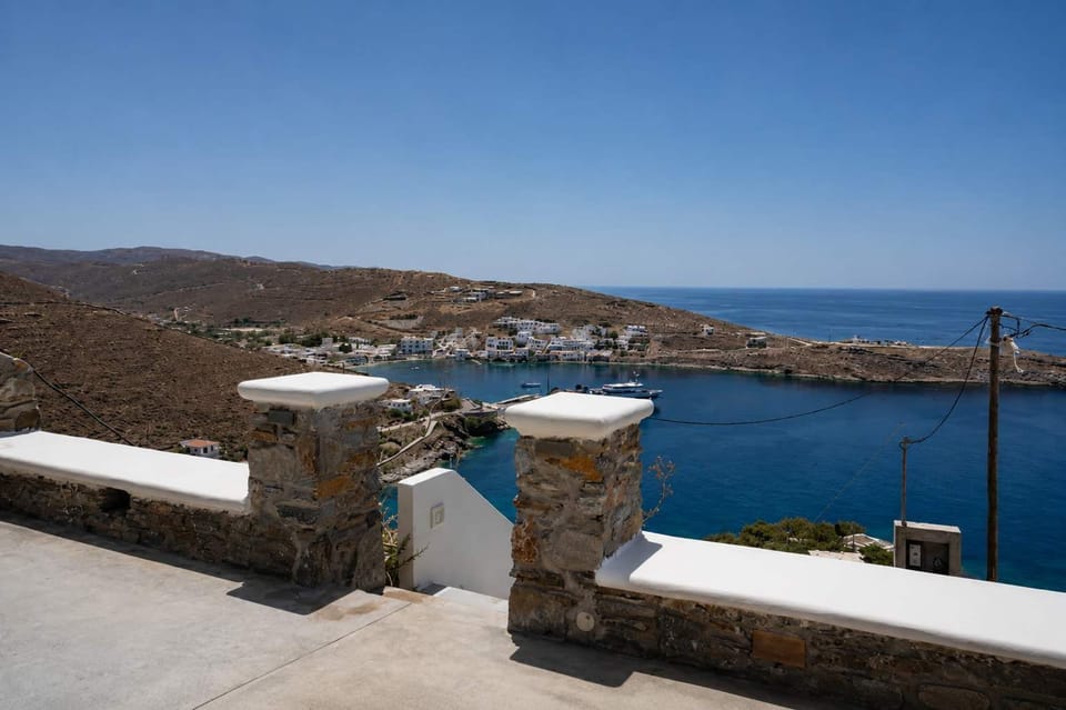Scenic Kythnos bay view from the villa, framed by stone walls and Cycladic charm.