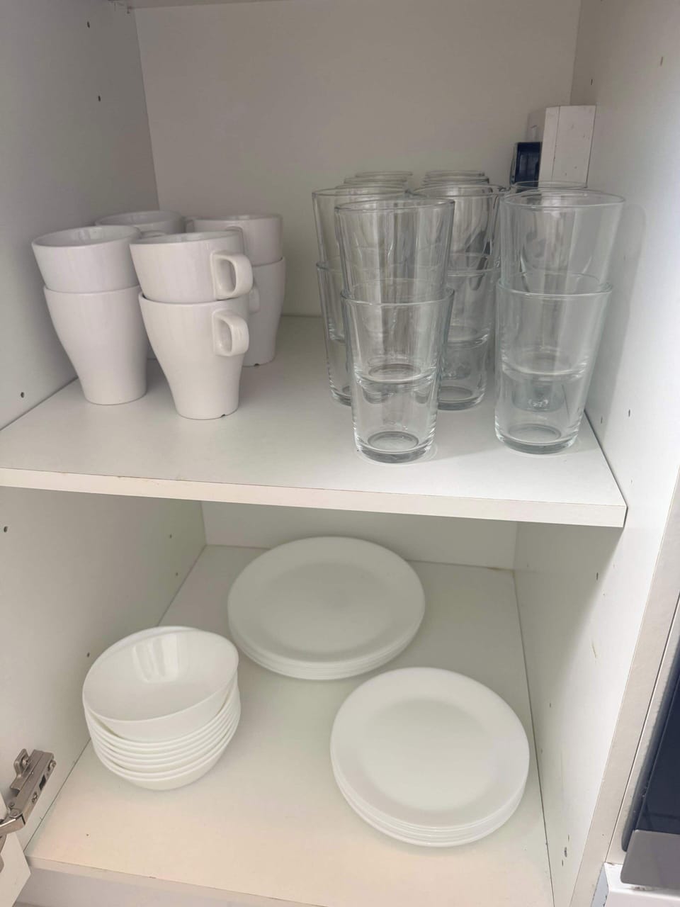 Well-equipped kitchen featuring essential appliances, cookware, crockery, and utensils for both short and extended stays.
