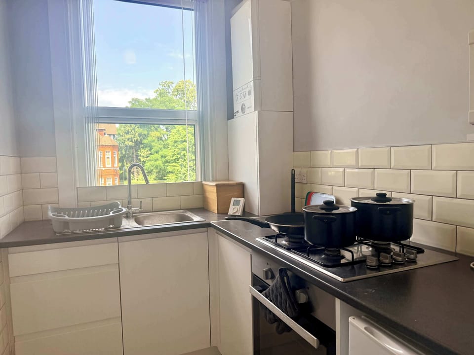 Well-equipped kitchen featuring essential appliances, cookware, crockery, and utensils for both short and extended stays.