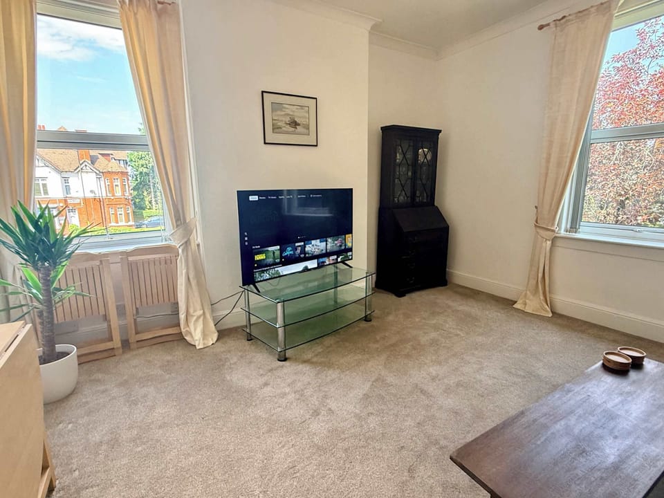 Relax in the comfortable living area with soft furnishings, natural light, and a Smart TV for your favourite films and shows.