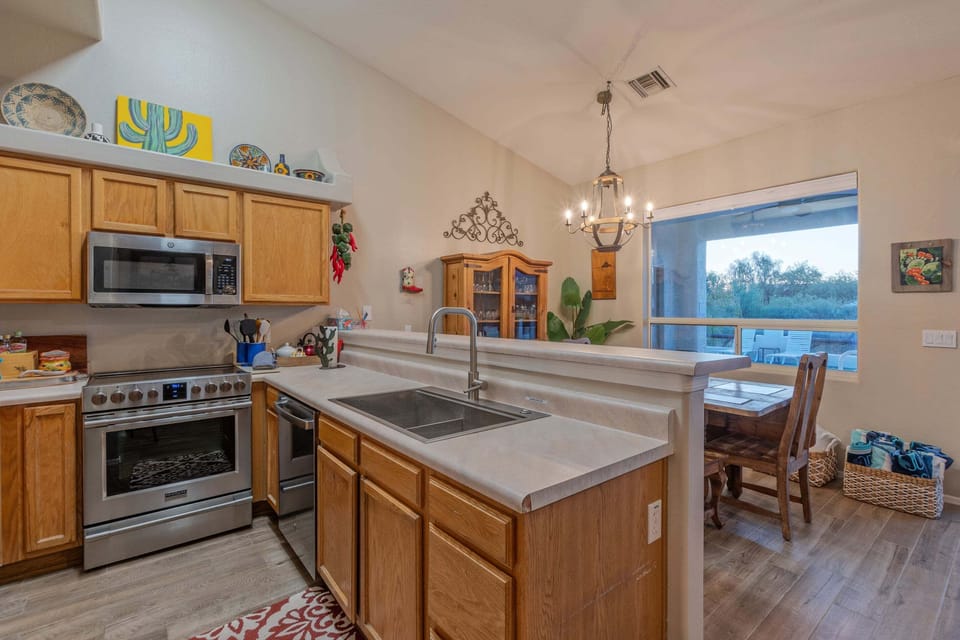 Kitchen opens into a dining area with a backyard view.