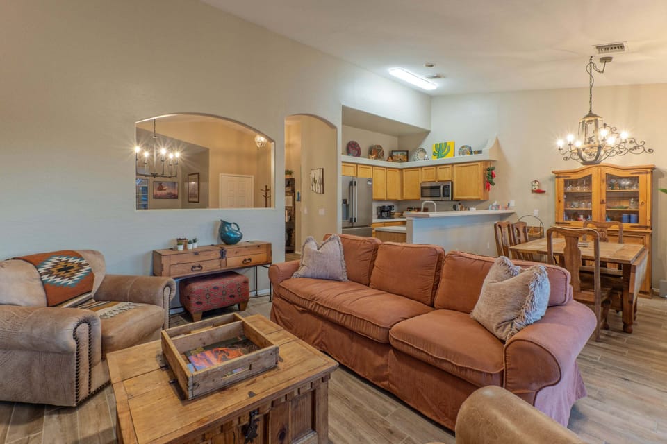 Open concept great room includes a sitting area, dining table, kitchen and breakfast nook.