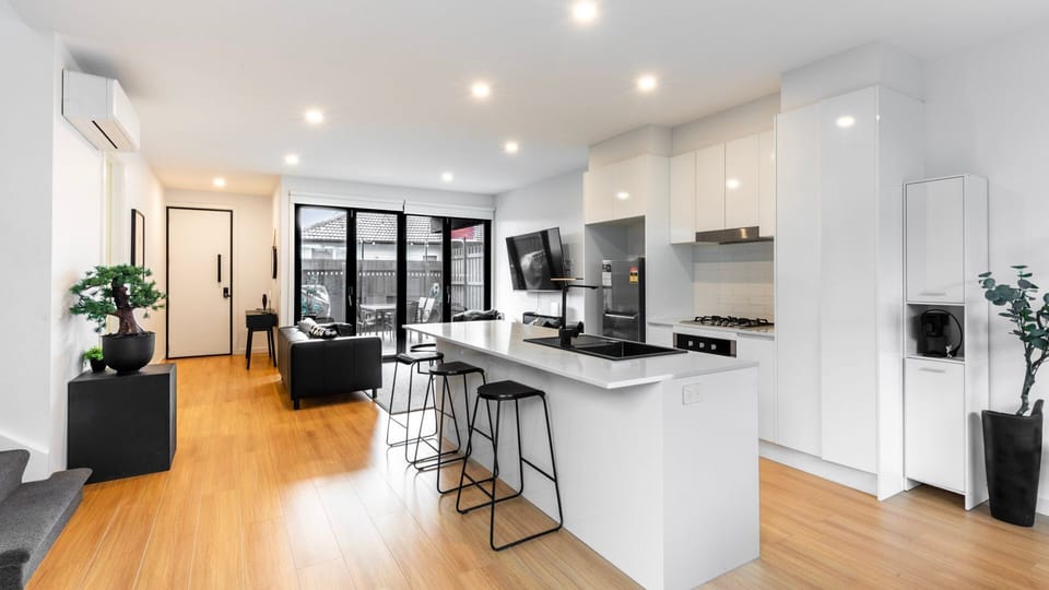 Cook, dine, and unwind in a modern open-plan kitchen and living space.
