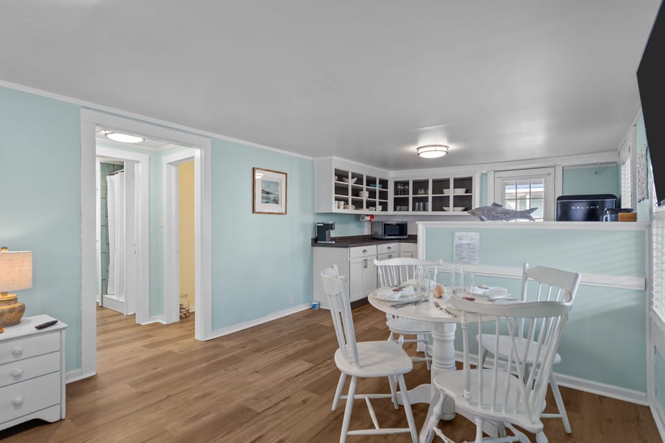 The dining table comfortably seats four and flows into the kitchen area