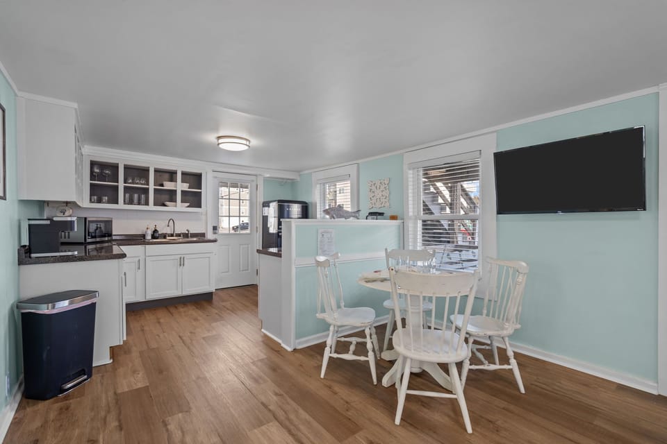 The dining table comfortably seats four and flows into the kitchen area