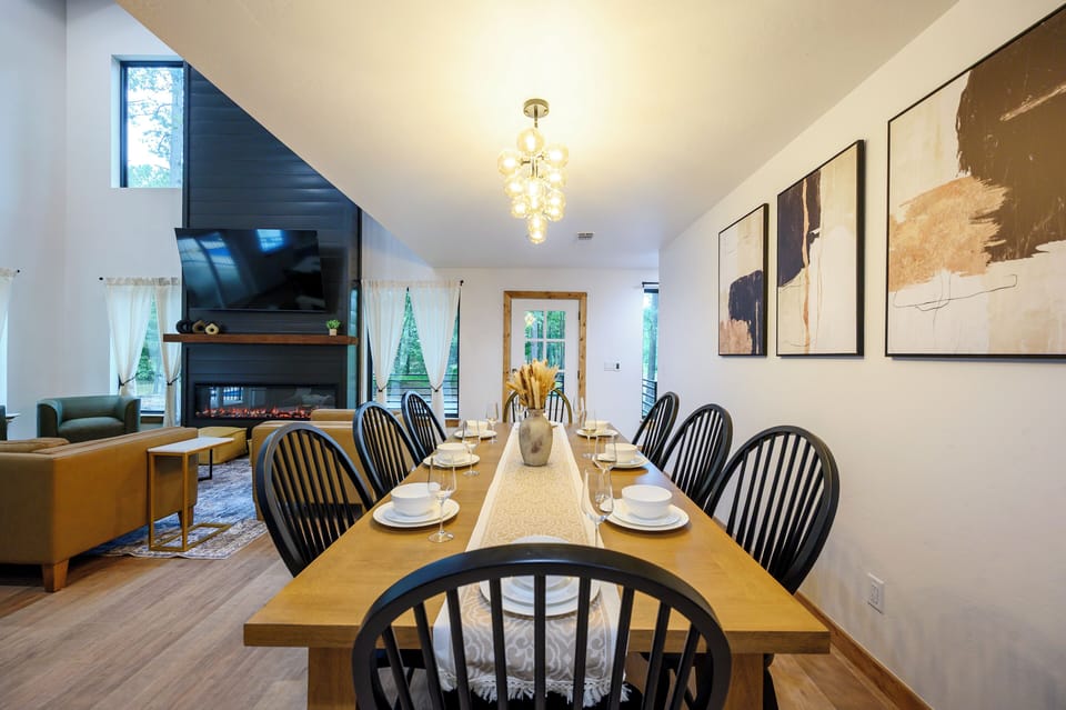 Spacious dining area with vaulted ceilings, fireplace, and stylish decor
