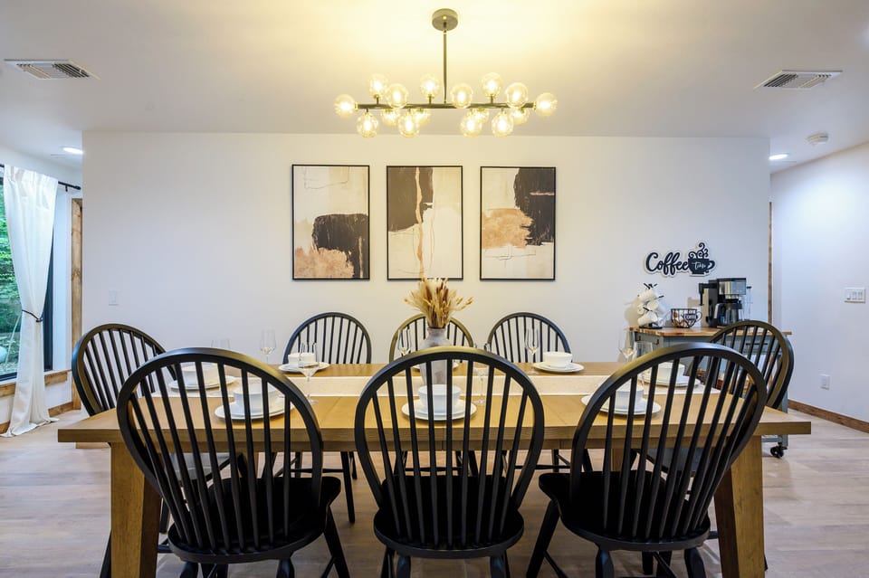 Spacious dining for 8 with modern lighting and a charming coffee bar