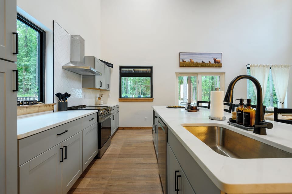 Bright modern kitchen with forest views and a spacious island