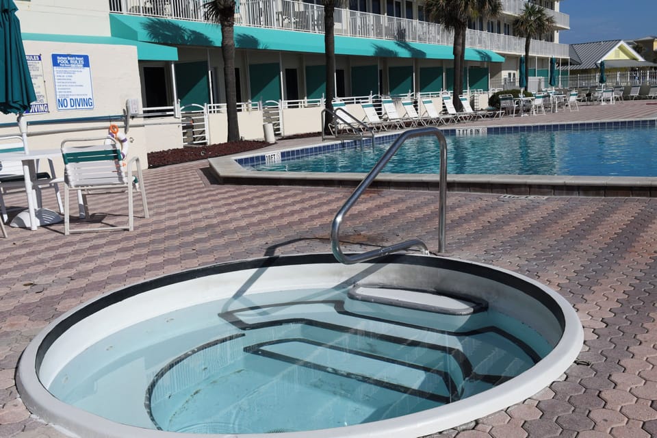 Soak away the day in your private hot tub, with the sparkling pool just steps away and palm trees swaying overhead.