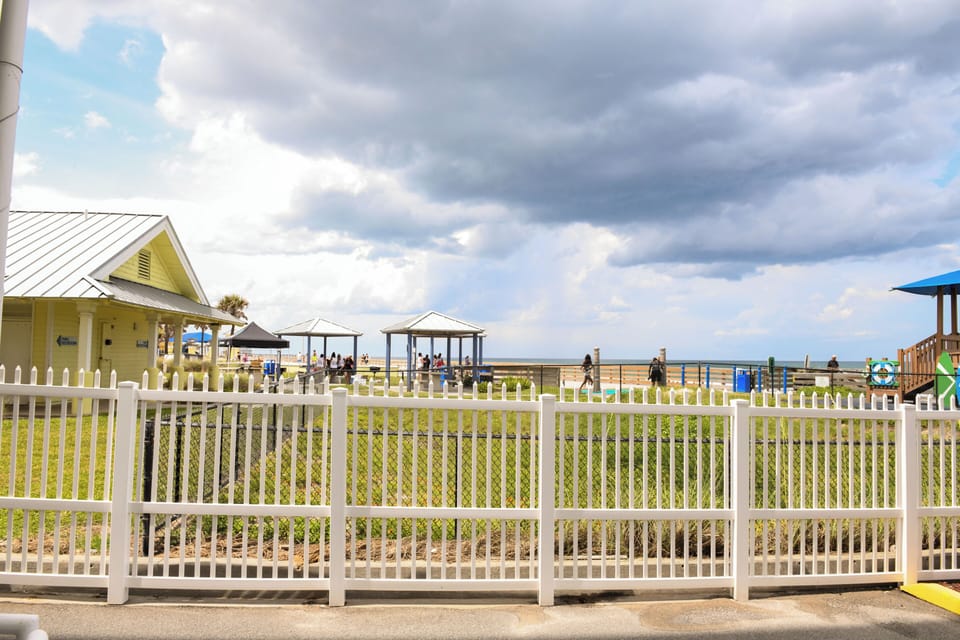 Beachfront property location with playground and covered pavilions along the shoreline, offering direct access to coastal recreation areas.