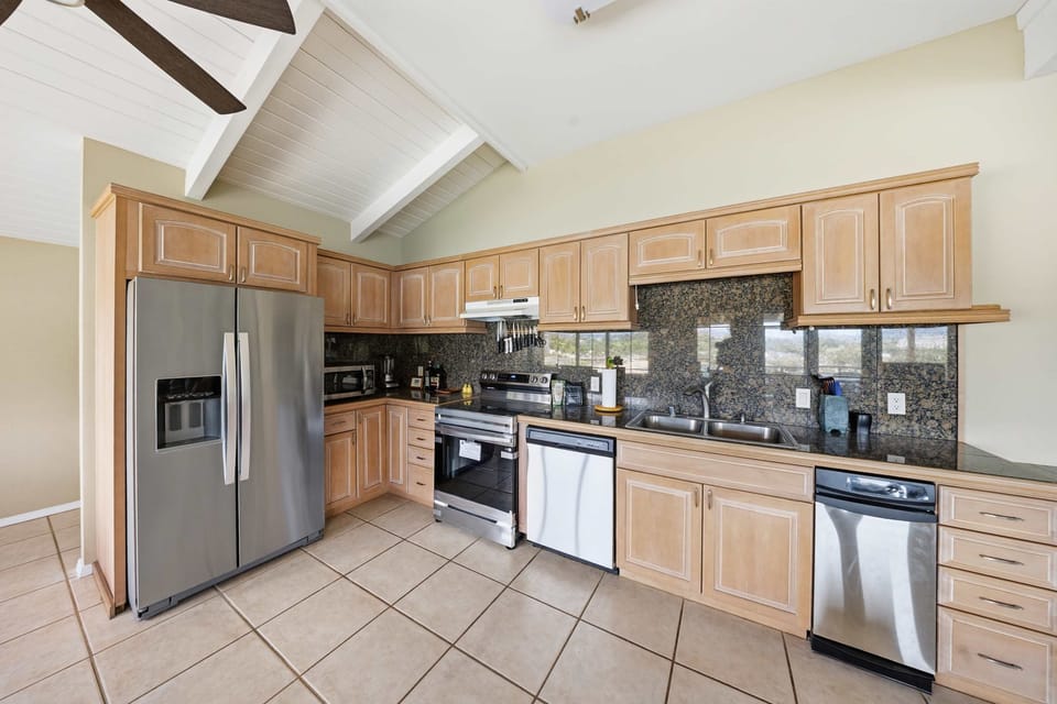 The heart of the home, this spacious kitchen and dining area offers breathtaking views of Kalapaki Bay and is fully stocked with everything you need for memorable meals together