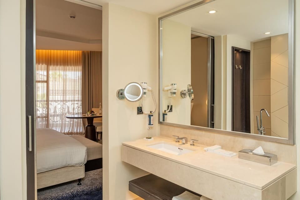 Separate tub and shower, hair dryer, slippers, towels