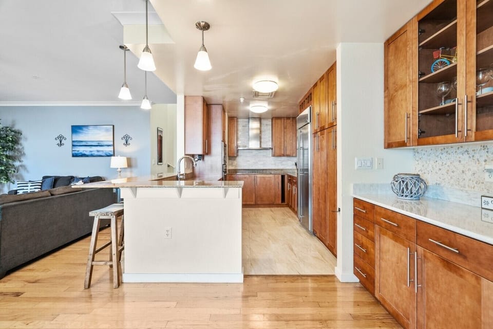The open layout keeps everyone connected, whether you`re preparing dinner, pouring drinks, or chatting with family in the living room