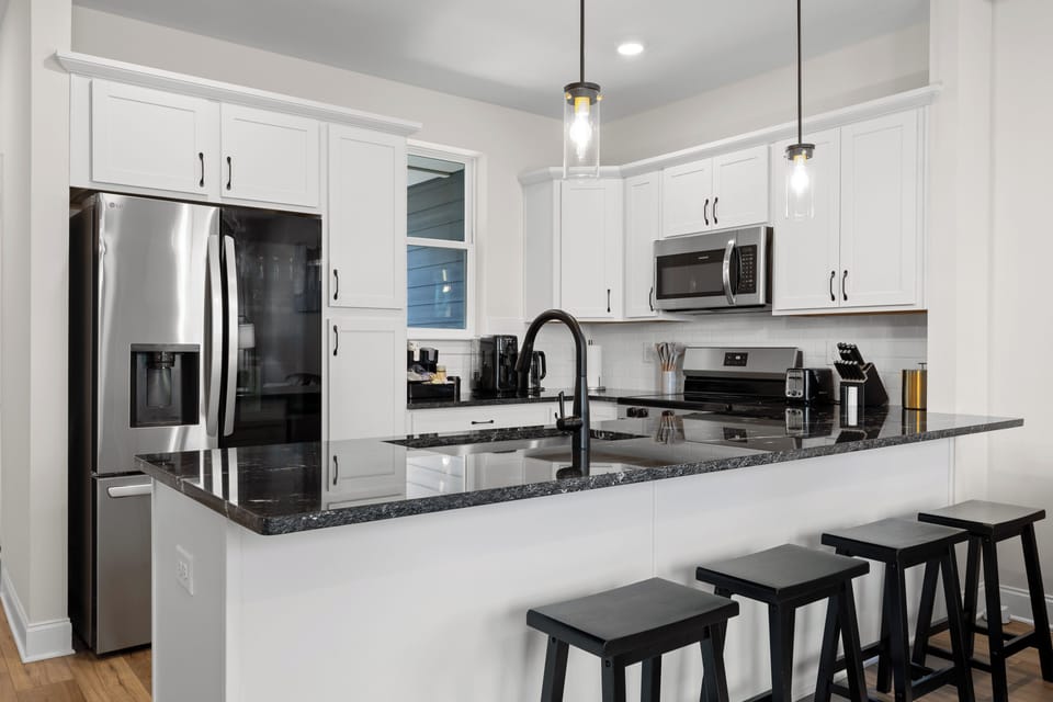 Bright modern kitchen with breakfast bar and stainless steel appliances