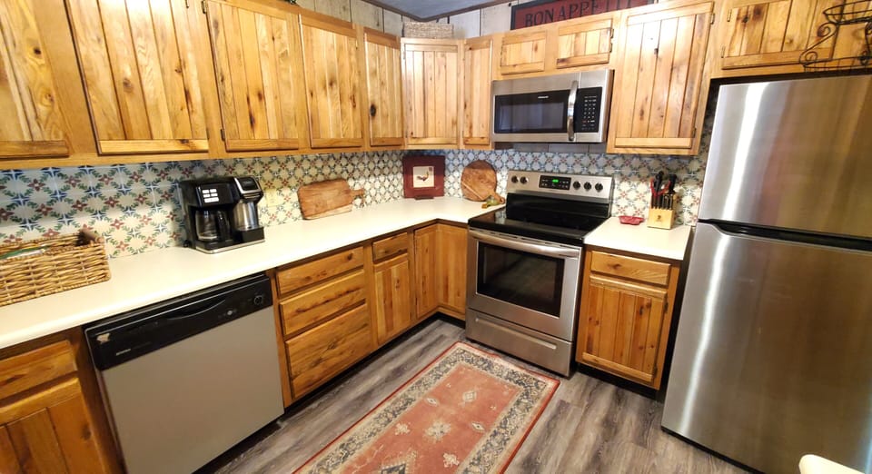 Your fully equipped kitchen features stainless steel appliances, warm wood cabinetry, and everything you need to prepare delicious home-cooked meals during your stay.