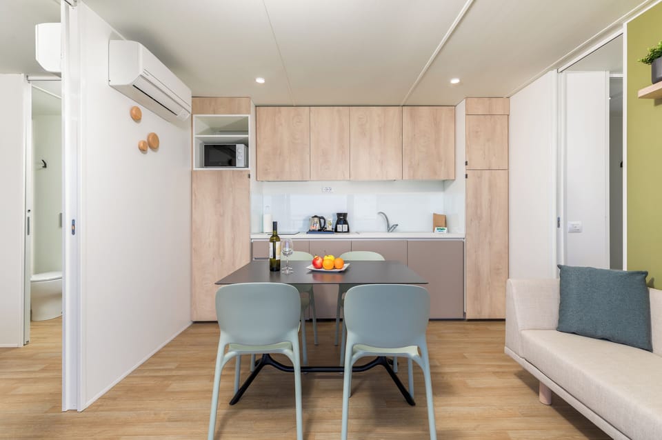 Full-size fridge, stovetop, electric kettle, cookware/dishes/utensils