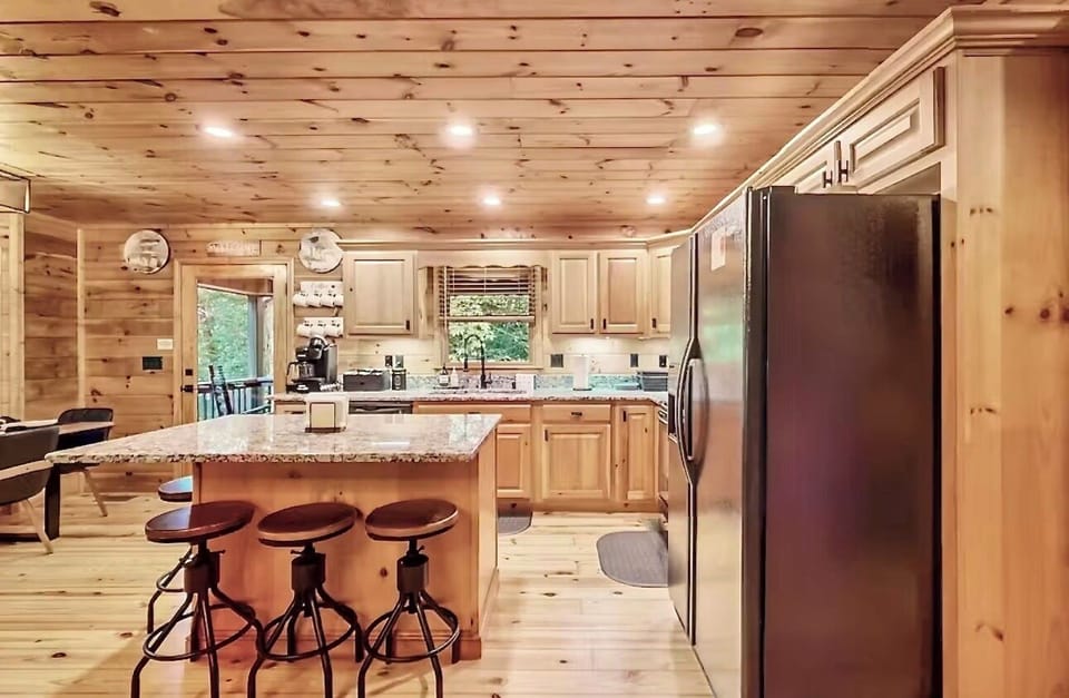 Full kitchen/counter island seats 4 /door leads to outdoor back porch