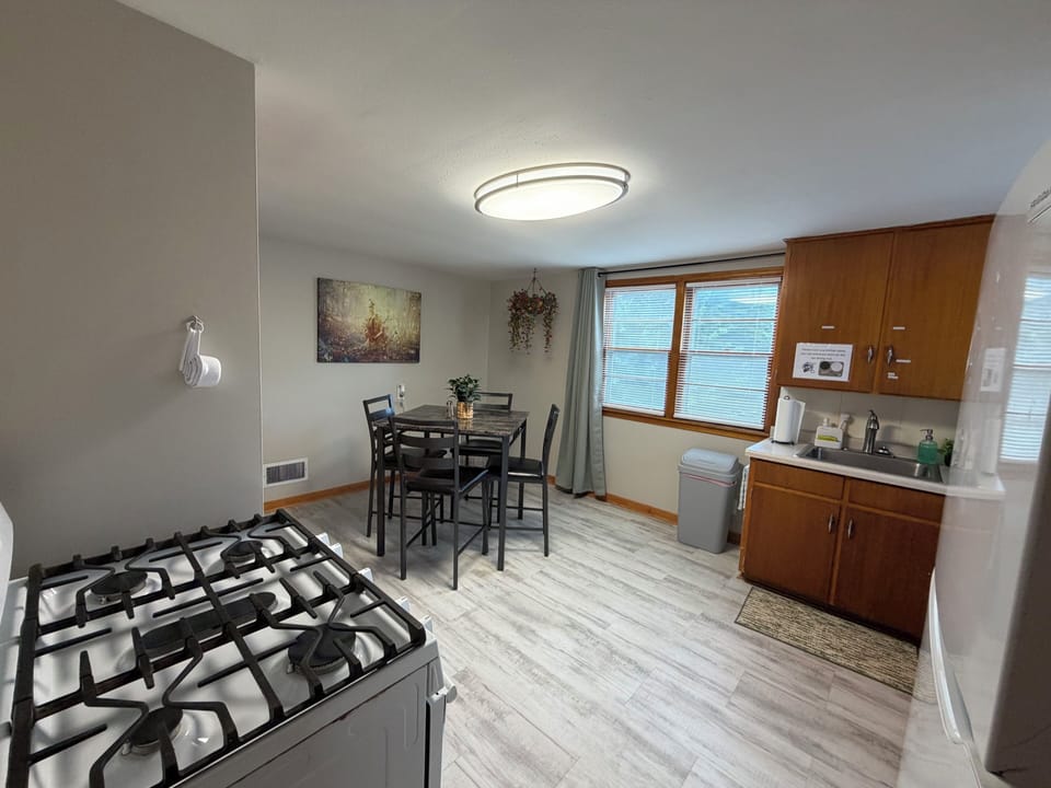 Dining table, gas oven, fridge/freezer, microwave, coffee maker, and more!