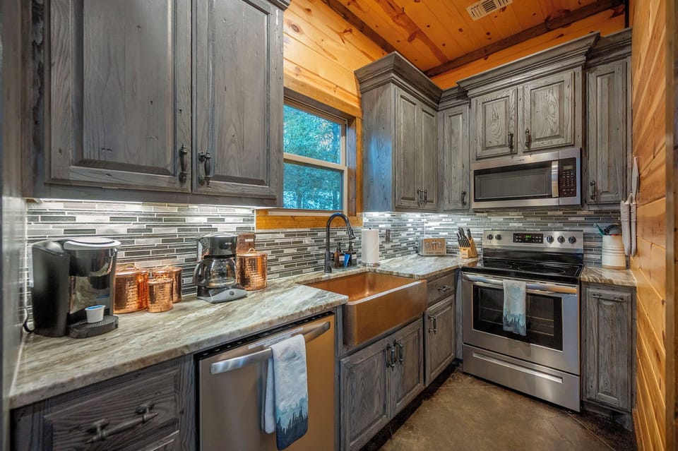 A fully equipped kitchen with rustic charm and modern touches.  