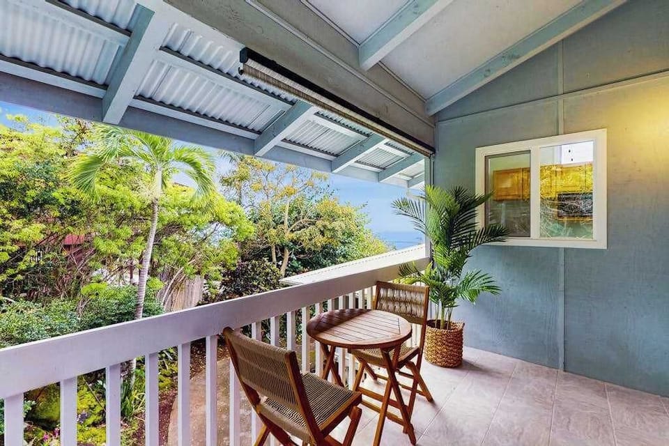 Covered balcony provides dining with tropical landscaping and ocean views