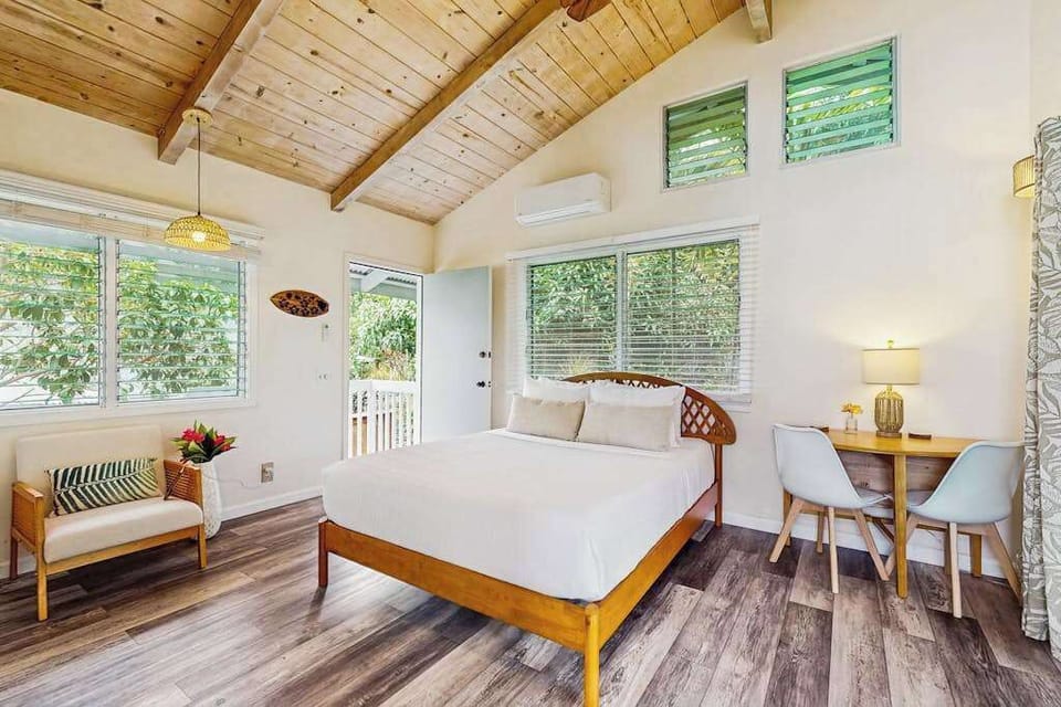 Studio sleeping area features queen bed ceiling fan and views