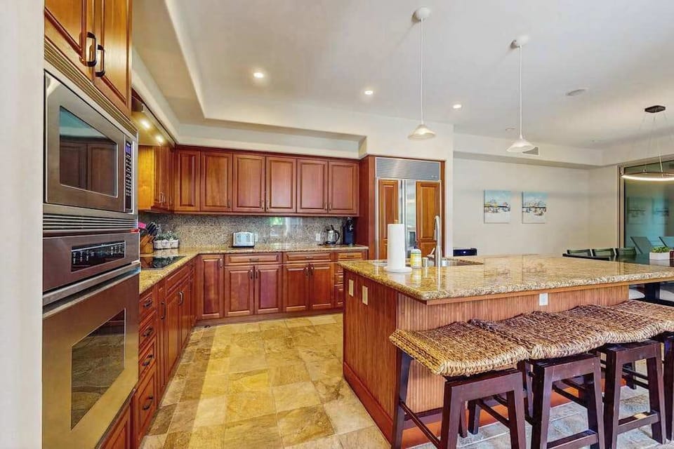 Upgraded kitchen with all of the amenities and stainless steel appliances.  Large island for extra counter space and with four barstools.