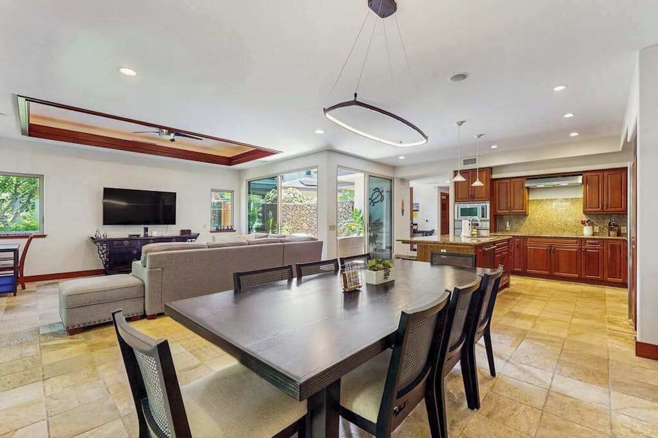 Living Room with plenty of seating with this comfortable sectional and open to the dining room and kitchen in this open floor plan design.
