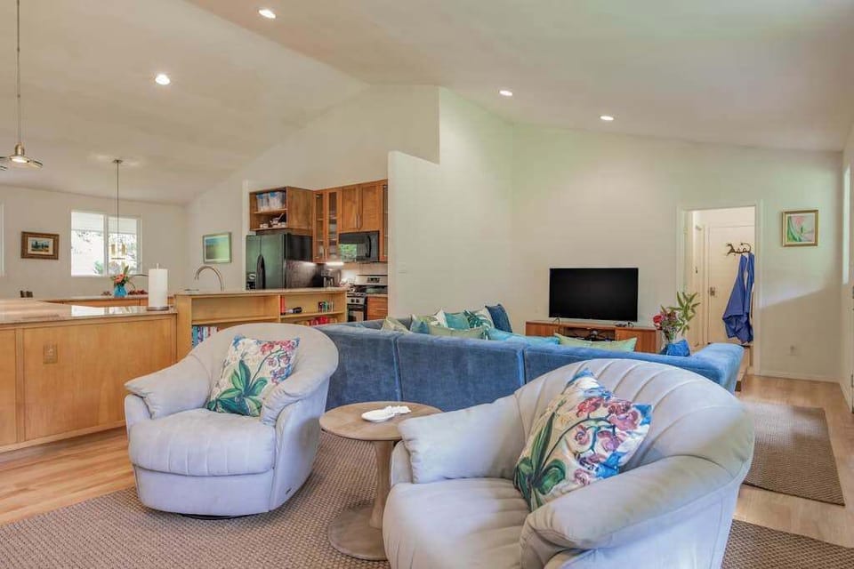 Sunlit Living Room with Plush Swivel Armchairs