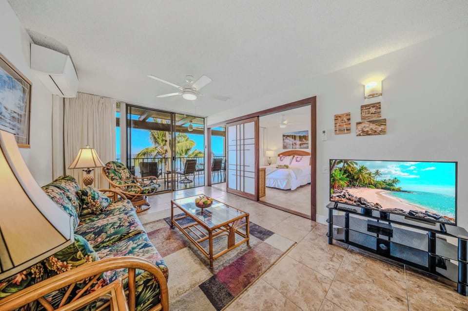 Spacious living area with comfortable seating, tropical accents, and direct balcony access. 🛋️