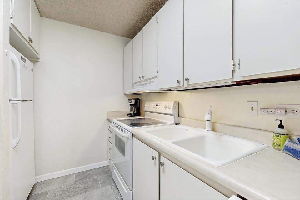 Fully Equipped Kitchen with Ample Countertops & White Cabinetry