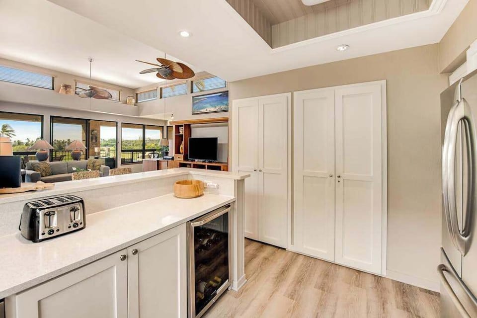 Kitchen connects counters, appliances, cabinetry, windows, dining, and living areas