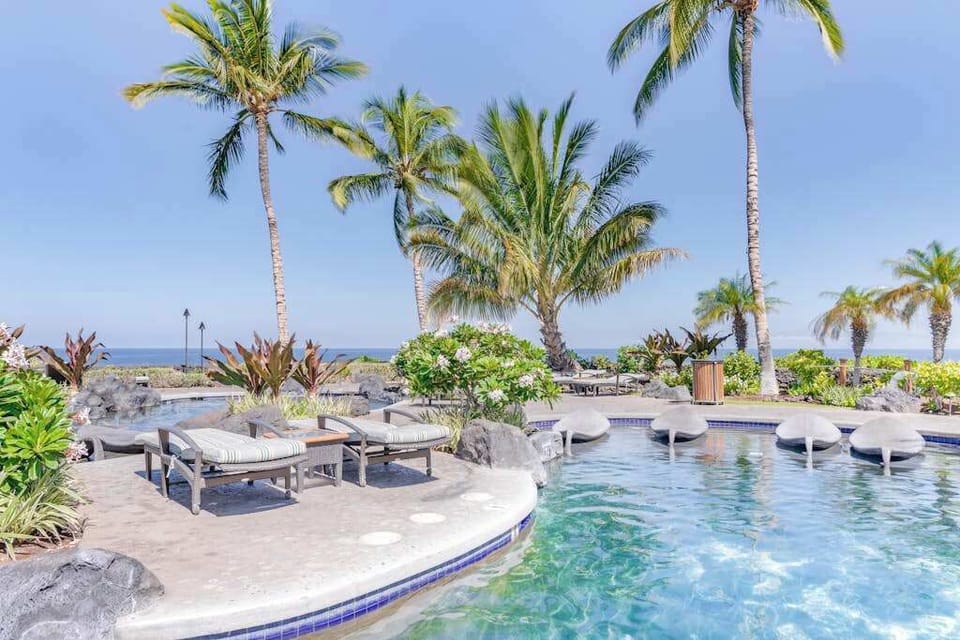 Resort-Style Swimming Pool surrounded by Tropical Palms