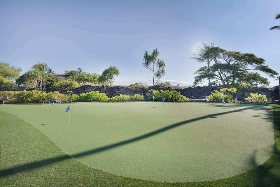 On-Site Golf Putting Green with Lush Tropical Surroundings