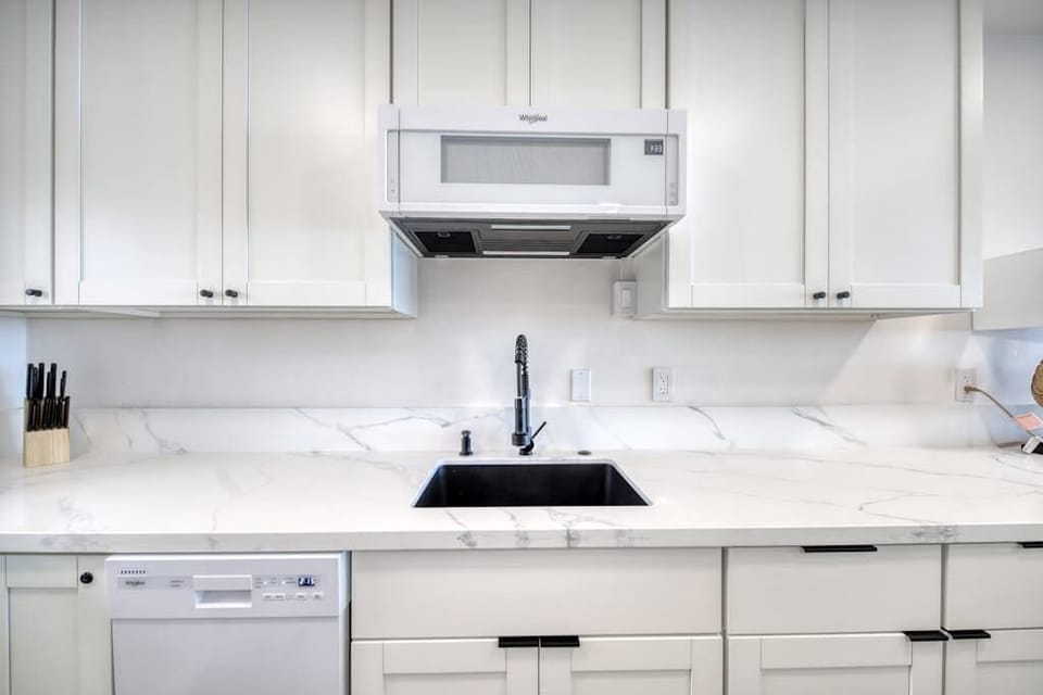 Sparkling Clean White Cabinetry And Premium Countertop Finishes