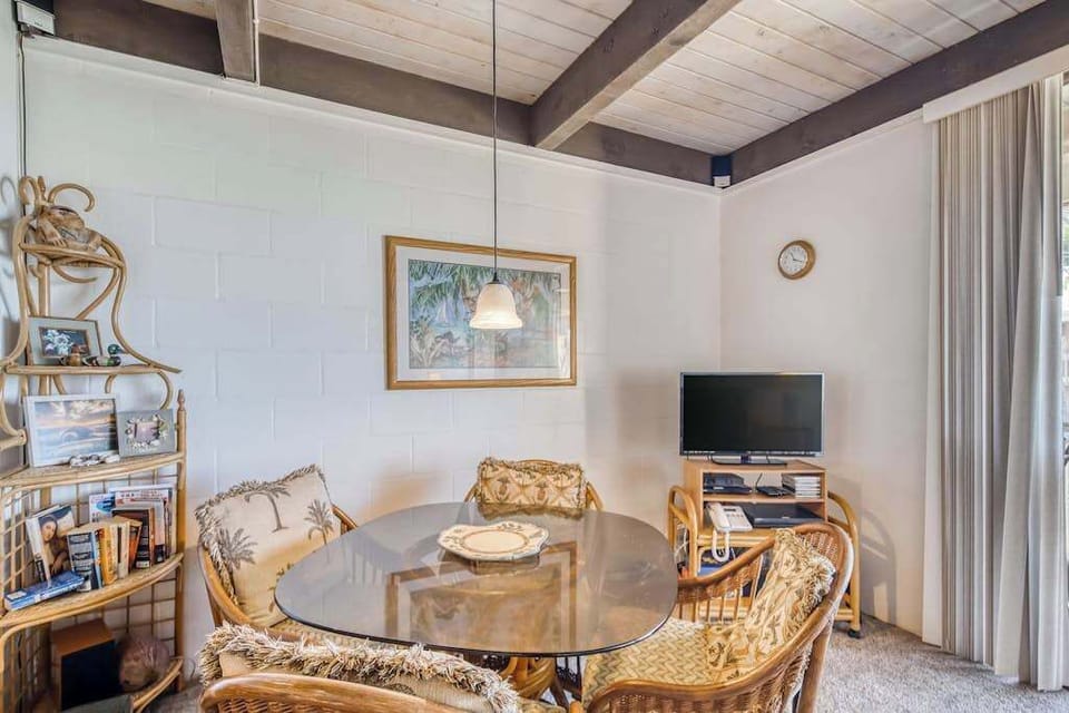 Detailed interior layout of the open living and dining area featuring premium bamboo furniture, a television corner, and high vaulted wooden ceilings! 🛋️📺✨🌴😎