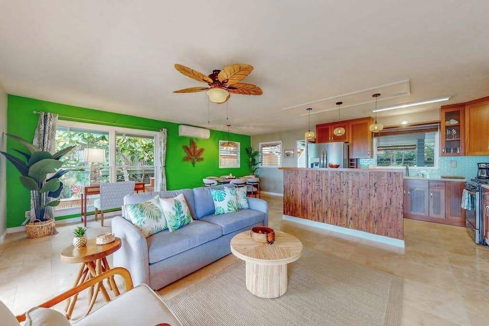 Open living area combines colorful furnishings kitchen and island light