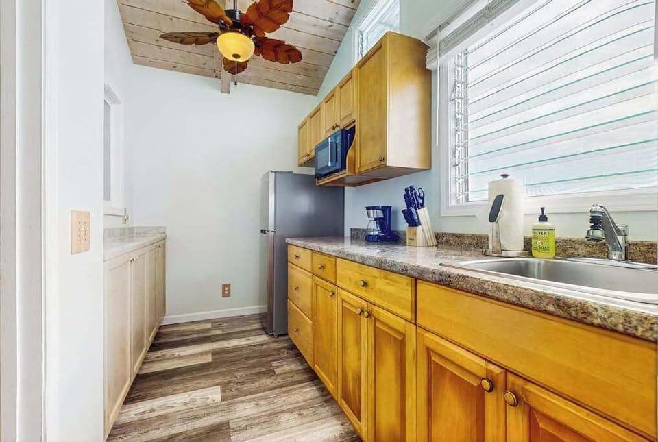 Kitchen offers wooden cabinetry countertop workspace and stainless appliances inside