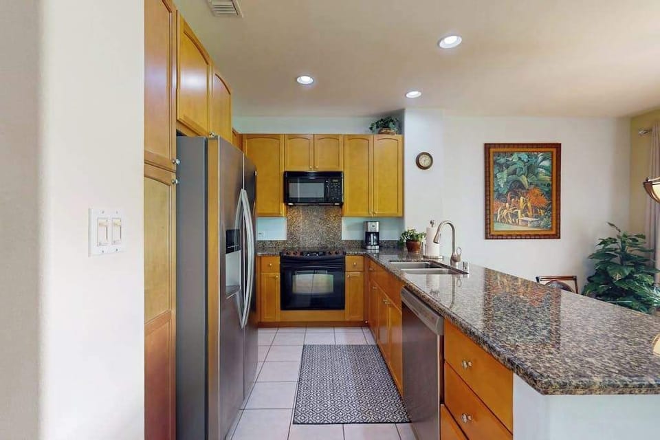 Fully stocked kitchen allowing the chef to prepare any meal.  Large countertop for extra prep space or for extra seating with the barstools for dining.