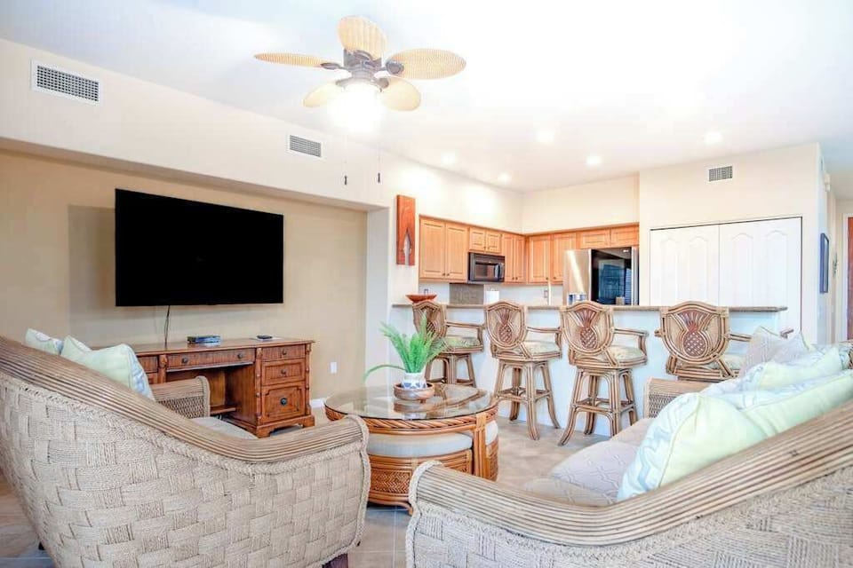 Open-Concept Living Room & Kitchen with Mounted TV & Breakfast Bar