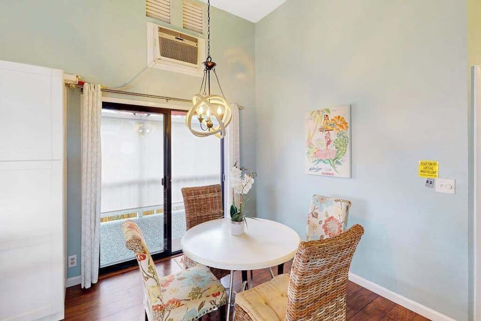 Bright dining area featuring a round table, stylish woven chairs, and large sliding doors with direct balcony access! 🍽️☀️
