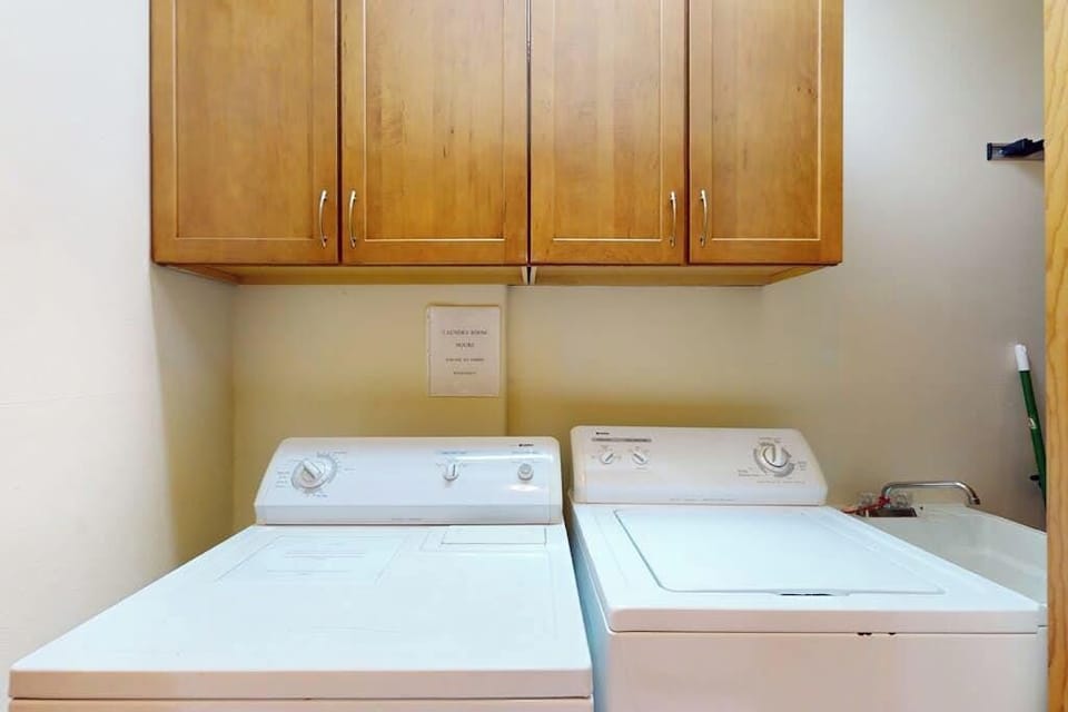 Washer and dryer area offers practical convenience during longer stays