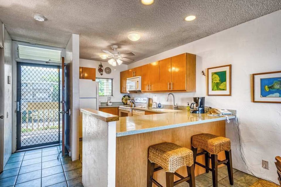 Functional kitchen area featuring a breakfast bar with barstools and plenty of counter space