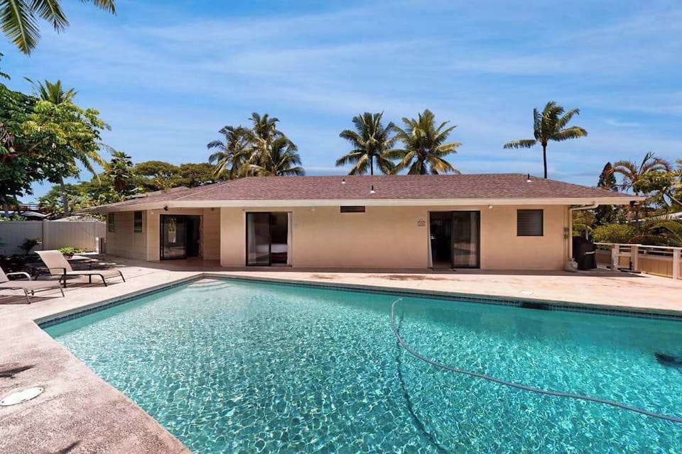 Sunny pool area offers views lounge seating and refreshing swims