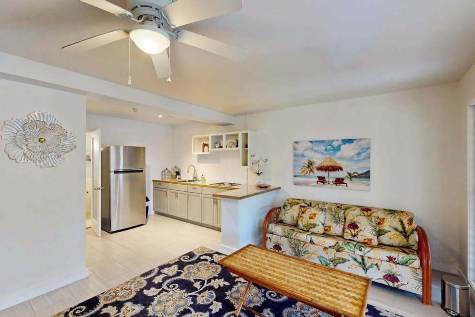 Living area features sofa seating ceiling fan and garden outlook