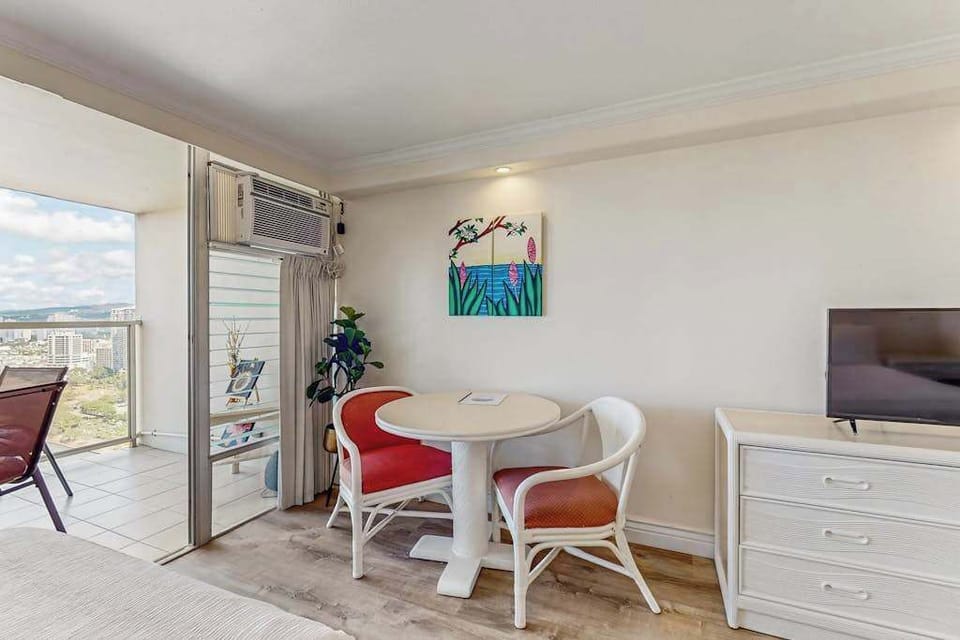 Designed for convenience, the studio layout includes a two-person dining nook, a flat-screen TV, and an air conditioning unit.