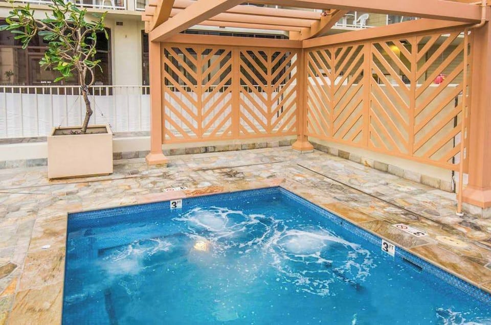 Relax in the shared jacuzzi, conveniently located near the common area pergola.