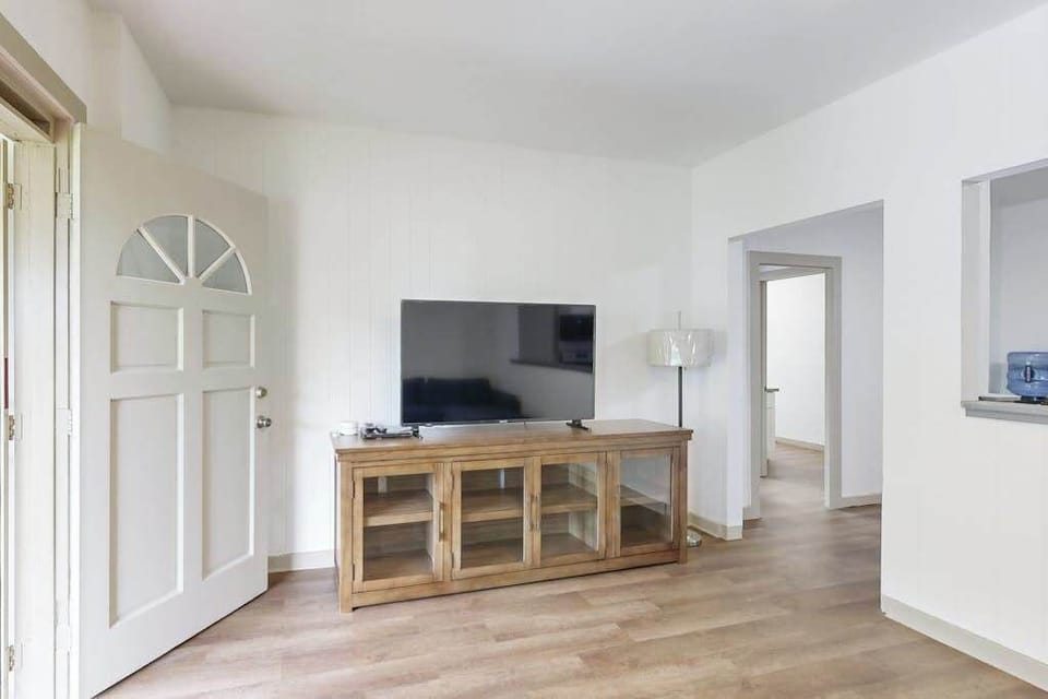 Relax and enjoy your favorite shows in a comfortable living room with a TV.