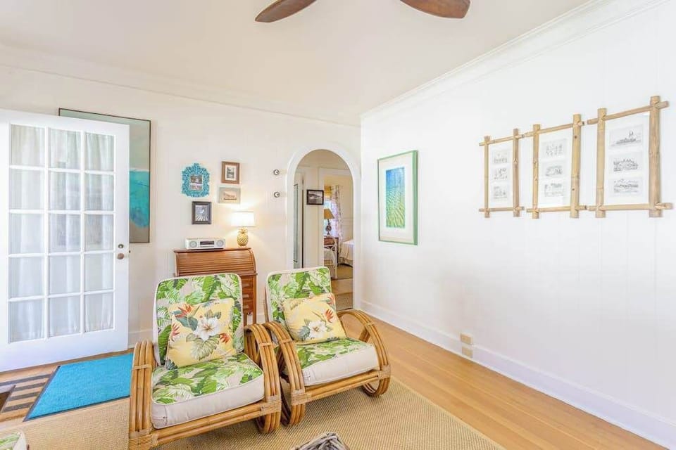Unwind in the bright living room with refreshing airflow from overhead fans