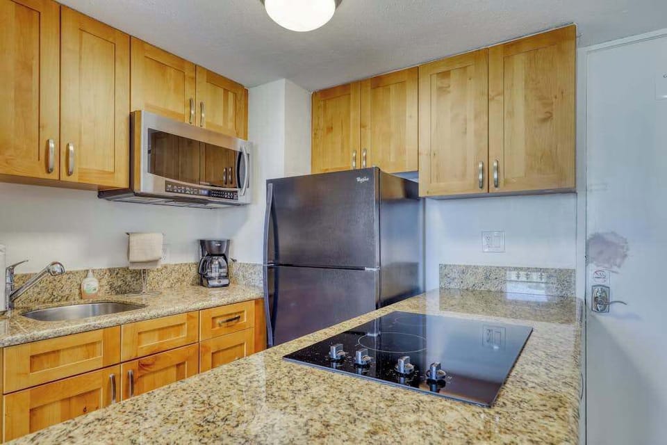 Fully equipped kitchen with granite countertops, full-size appliances, coffee maker, and everything needed for home-cooked meals.