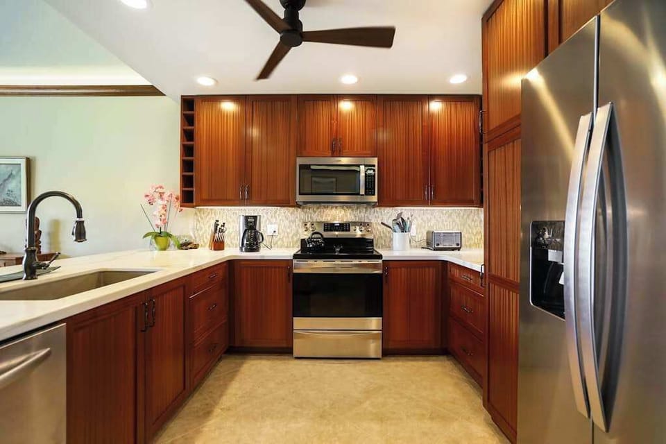 Fully stocked stainless steel kitchen.